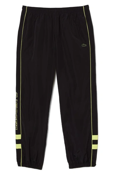 Shop Lacoste Water Resistant Athletic Pants In 6vt Noir/ Limeira