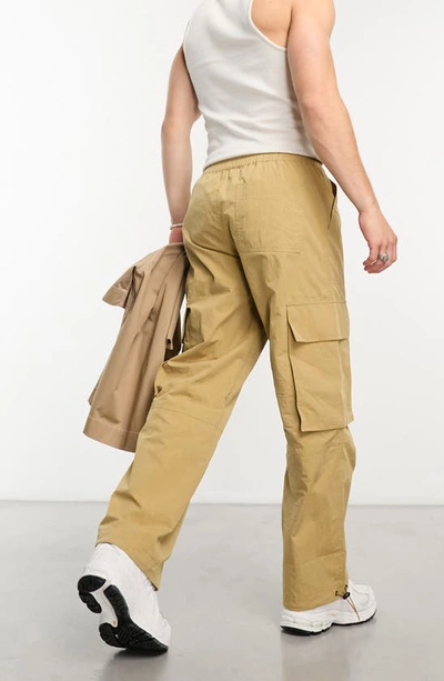 Shop Asos Design Wide Leg Poplin Cargo Pants In Beige