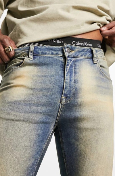 Shop Asos Design Spray-on Skinny Jeans In Mid Blue