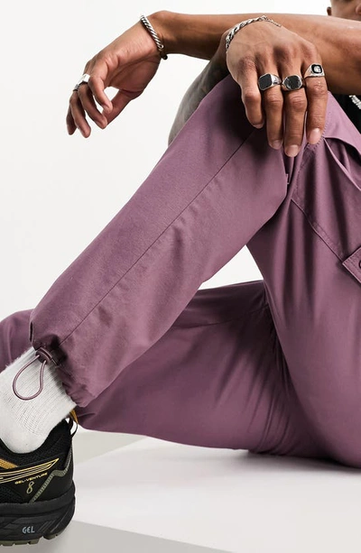 Shop Asos Design Tapered Cargo Trousers In Purple