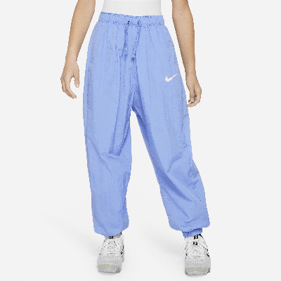 Shop Nike Sportswear Big Kids' (girls') Woven Pants In Blue