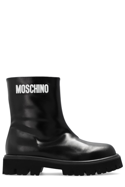 Shop Moschino Logo Printed Ankle Boots In Black