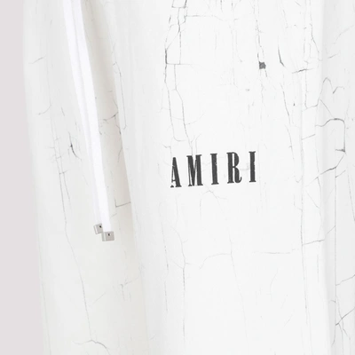 Shop Amiri Cracked Dye Logo Sweatpants In White
