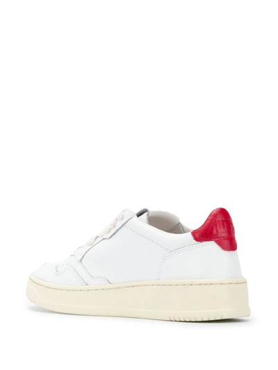 Shop Autry Contrasting Heel Sneakers In Wht/red