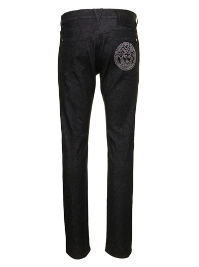 Shop Versace Black Straight Jeans With Studded Medusa In Stretch Cotton Denim Man