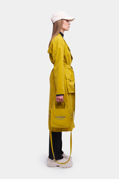 Shop Stutterheim Kista Matte Trench Coat Gold In Golden Palm