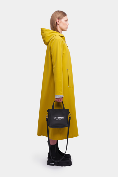 Shop Stutterheim Mosebacke Long Matte Raincoat Gold In Golden Palm