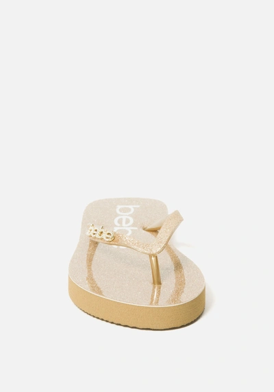 Shop Bebe Tracee  Logo Flip Flops In Gold