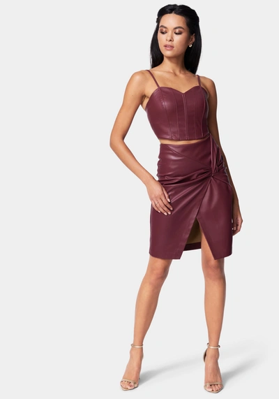 Shop Bebe Vegan Leather Knot Front Skirt In Bloodstone