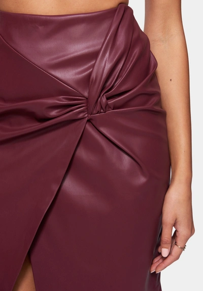 Bebe Vegan Leather Knot Front Skirt In Bloodstone