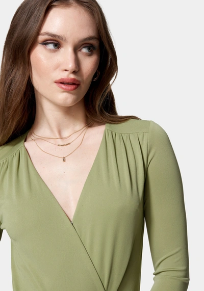 Shop Bebe Wrap Front Knit Bodysuit In Sage