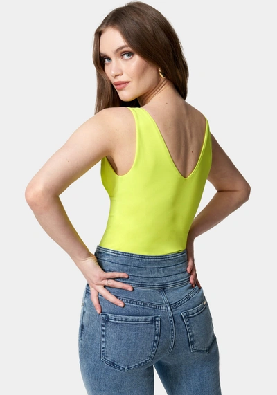 Shop Bebe Sleeveless Ruched Deep V Knit Bodysuit In Cyber Lime