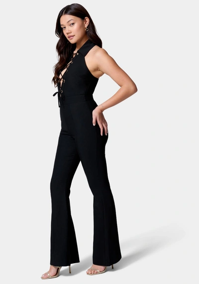 Shop Bebe Satin Twill Sleeveless Eyelet Detail Wide Leg Jumpsuit In Black