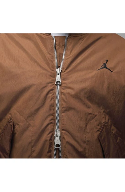 Shop Jordan Essentials Renegade Water Repellent Bomber Jacket In Light British Tan/ Black