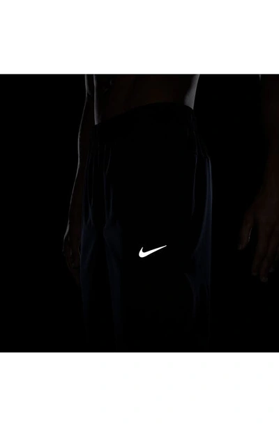 Shop Nike Form Dri-fit Versatile Pants In Obsidian/ Black/ Silver