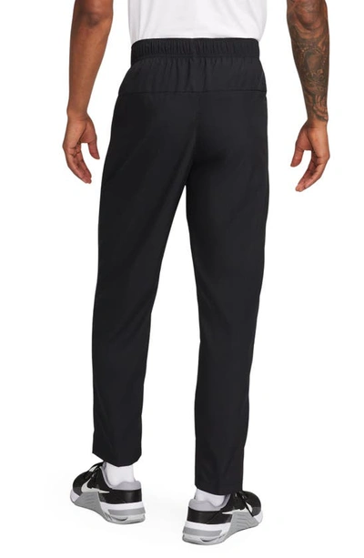 Shop Nike Form Dri-fit Versatile Pants In Black/ Silver