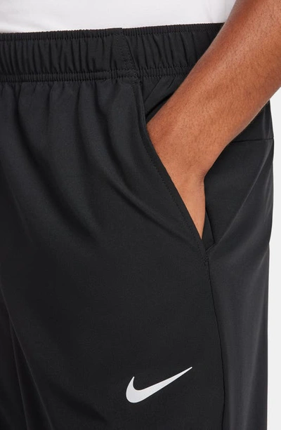 Shop Nike Form Dri-fit Versatile Pants In Black/ Silver