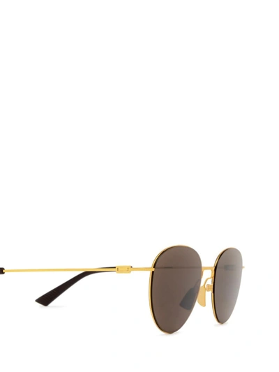 Shop Bottega Veneta Sunglasses In Gold