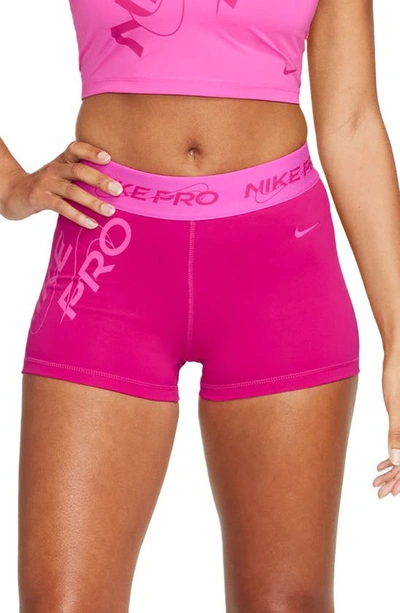 Shop Nike Pro Mid Rise Graphic Training Shorts In Fire Berry/ Laser Fuchsia