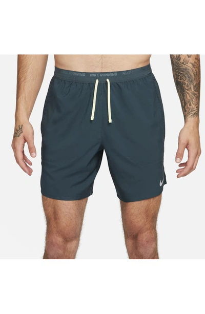 Shop Nike Dri-fit Stride 7-inch Brief-lined Running Shorts In Deep Jungle/ Luminous Green