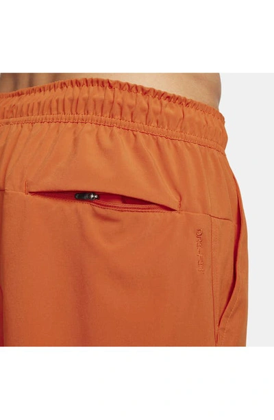 Shop Nike Dri-fit Unlimited 5-inch Athletic Shorts In Campfire Orange