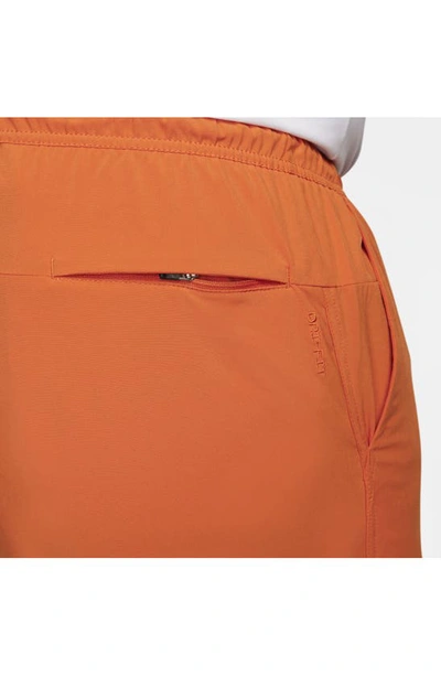 Shop Nike Dri-fit Unlimited 5-inch Athletic Shorts In Campfire Orange