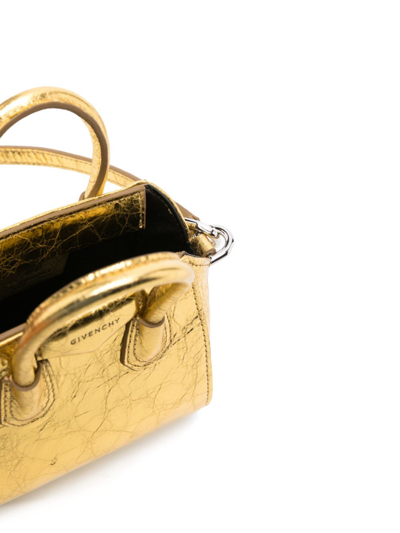 Shop Givenchy Antigona Micro Leather Crossbody Bag In Gold