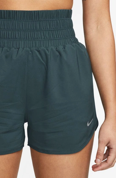 Shop Nike Dri-fit Ultrahigh Waist 3-inch Brief Lined Shorts In Deep Jungle/ Reflective Silv