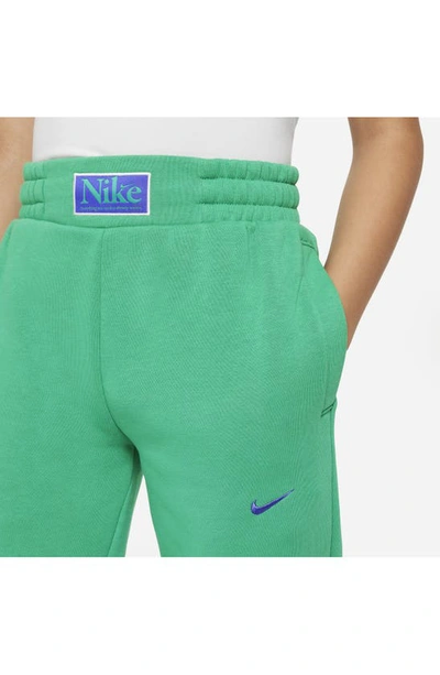 Shop Nike Kids' Fleece Basketball Joggers In Stadium Green/ Blue Joy