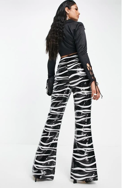 Shop Asos Design Animal Print Sequin Flare Trousers In Black