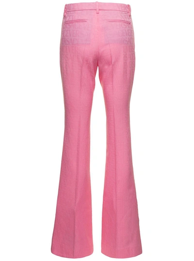 Shop Versace Pink Flare Pants With Tonal Logo Lettering In Wool Woman