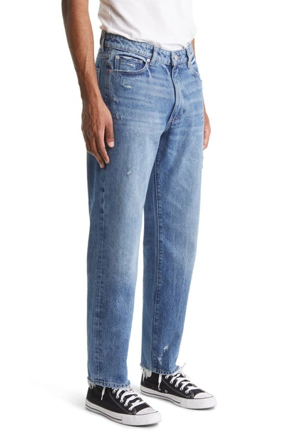 Shop Dl1961 Noah Tapered Straight Leg Jeans In Indigo Distressed