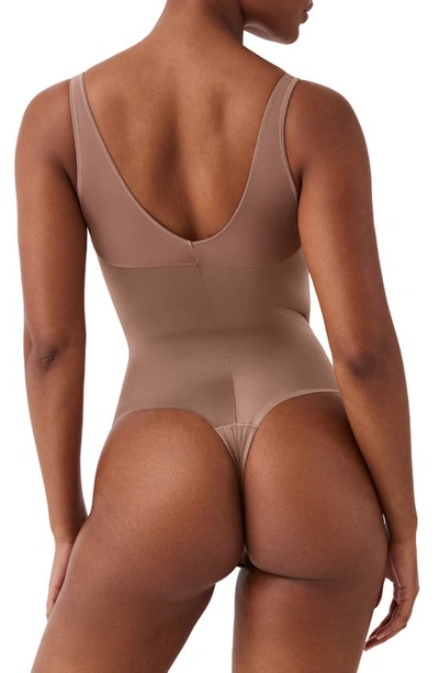 Shop Spanx Shaping Satin Thong Bodysuit In Cafe Au Lait