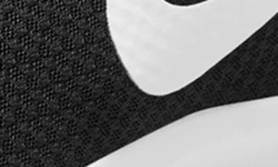 Shop Nike Tanjun Athletic Sneaker In Black/white-barely Volt-black
