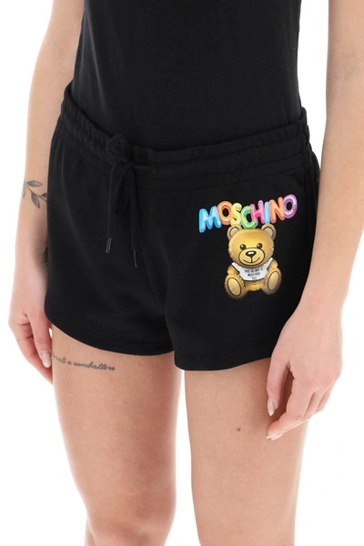 Shop Moschino Logo Printed Shorts In Black