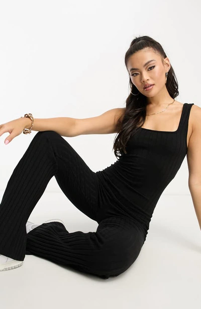 Shop Asos Design Rib Flare Leg Stretch Cotton Jumpsuit In Black