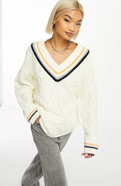 Shop Asos Design V-neck Cable Knit Varsity Sweater In Cream