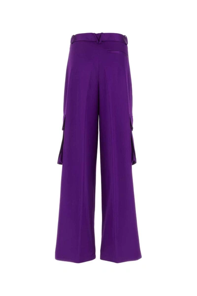 Shop Versace Pants In Purple