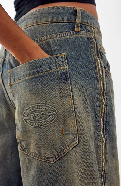 Shop Bdg Urban Outfitters Jaya Tinted Side Zip Low Rise Wide Leg Jeans In Vintage Denim