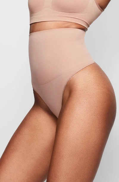 Shop Skims Core Control Thong In Sienna