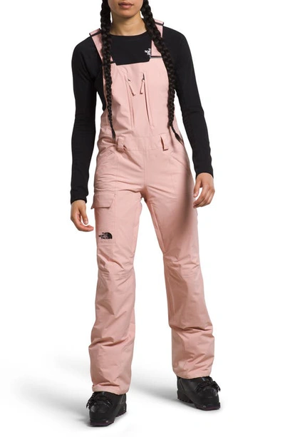 Shop The North Face Freedom Waterproof Snow Bib Overalls In Pink Moss