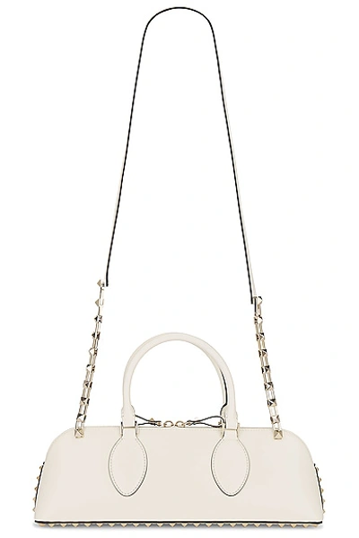 Shop Valentino East West Rockstud Duffle Bag In Ivory