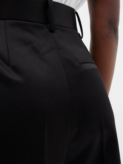 Shop Khaite Teyana Pleated Cotton-blend Trousers In Black