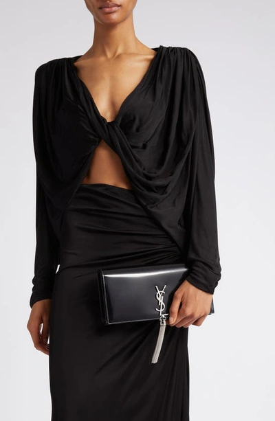 Shop Saint Laurent Kate Glossy Leather Clutch In Noir