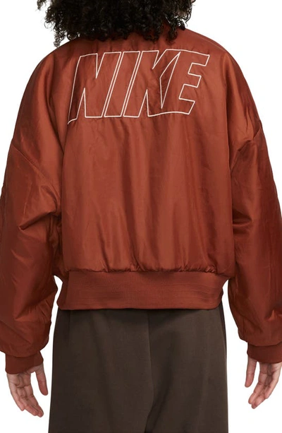 Shop Nike Sportswear Reversible Faux Fur Bomber Jacket In Rugged Orange/ Guava Ice