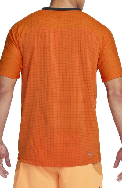 Shop Nike Dri-fit Trail Solar Chase Performance T-shirt In Campfire Orange/ Night Maroon