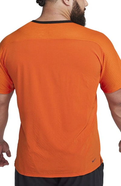 Shop Nike Dri-fit Trail Solar Chase Performance T-shirt In Campfire Orange/ Night Maroon
