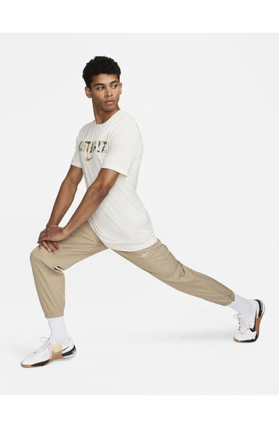 Shop Nike Dri-fit Tapered Versatile Pants In Khaki/ Black/ Silver