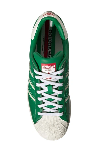 Shop Adidas Originals Superstar Sneaker In White/ Off White/ Red