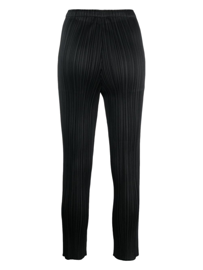 Shop Issey Miyake Pleated Cropped Trousers In Black